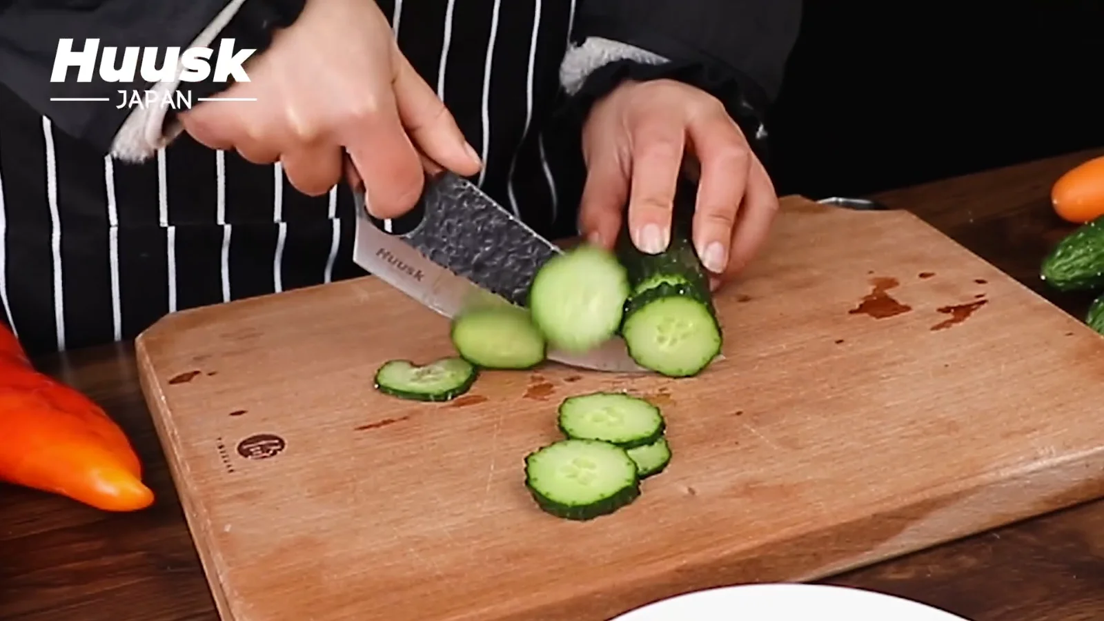 Cucumber on a wooden board: the cut a forged blade is ground for, straight down with no pressure behind it.